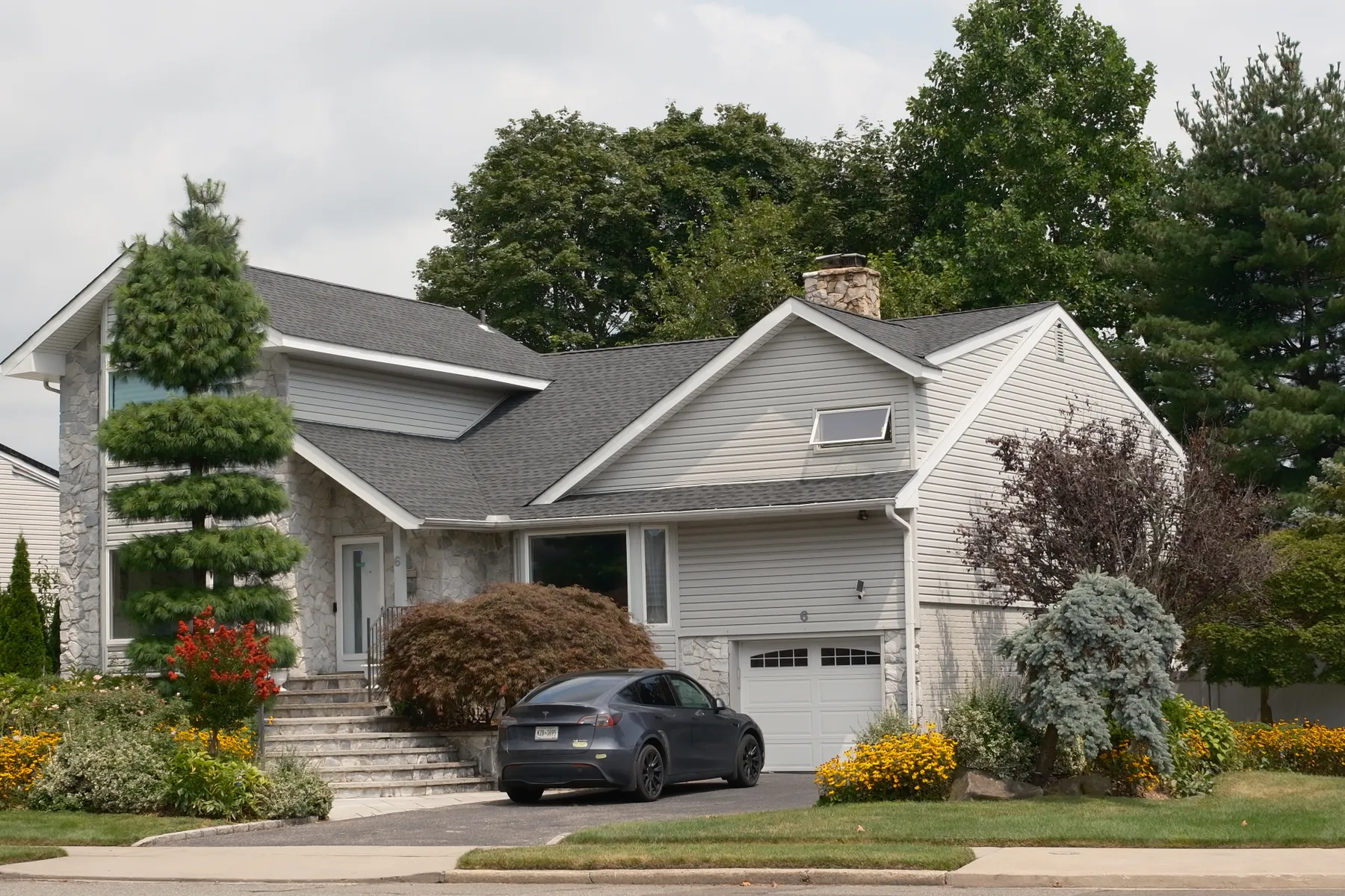 Suburban home with a vehicle in the driveway